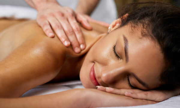 Close-up of beautiful woman having back massage at health spa.